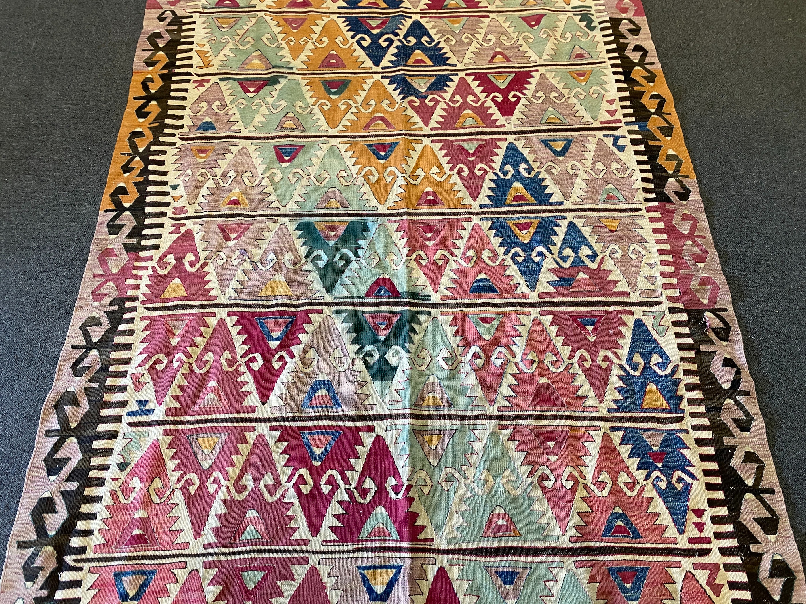 An Anatolian Kilim flatweave polychrome hall carpet, 410 x 156cm